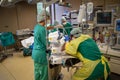 Anaesthesiologist in protective gear ventilating a Covid-19 patient in an operating room
