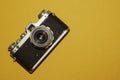 Analog camera on yellow background. copy space