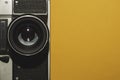 Analog camera on yellow background. copy space