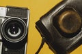 Analog camera on yellow background. copy space