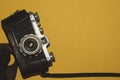 Analog camera on yellow background. copy space