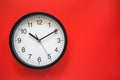 Analog classic black and white clock on red background Royalty Free Stock Photo