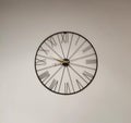 Analog clock with roman number on gray wall