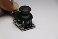 Analog joystick module used in arduino projects. Arduino Joystick module held in hand on white background