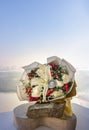 Analog pocket watch on the middle of the Bouquet of flowers placed on stone boulder and timber on the room balcony Royalty Free Stock Photo