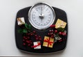 Analog scale surrounded by Christmas decorations. Overweight left after Christmas holidays. Royalty Free Stock Photo