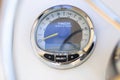 Analog tachometer on the white dashboard control panel of the motor boat Royalty Free Stock Photo