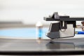 Stylus on vinyl record. Close up of turntable cartridge with needle and lp plate, blurred background, copy space Royalty Free Stock Photo