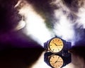 Analog Watch with Reflection and Smoke in Background.