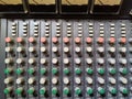 Analogue mixing console channels showing eq section and phantom power buttons line mic