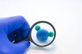 Analysis or laboratory testing of water for quality and safety concept photo. Researcher looking through magnifying glass on mode Royalty Free Stock Photo