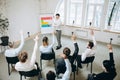 Male speaker giving presentation in hall at workshop. Audience or conference hall. Top view of unrecognized participants Royalty Free Stock Photo