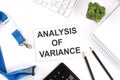 ANALYSIS OF VARIANCE Words on card with keyboard and office tools