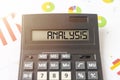 ANALYSIS word on calculator display close up and documents with colorful charts statistics. business financial report concept Royalty Free Stock Photo