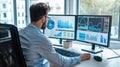 Analyst examining data on multiple computer