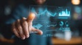 Analyst interacts with advanced holographic touchscreen to display complex data visuals in a modern office Royalty Free Stock Photo
