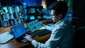 Analyst working at night in virtual meeting surrounded by futuristic blue data interfaces. Collage Royalty Free Stock Photo
