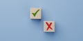 Analyze pros and cons. green tick and red cross in focus on wooden cube on blue background. consider all arguments pros and cons. Royalty Free Stock Photo