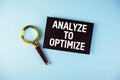 Analyze to Optimize text with Magnifying glass on blue background Royalty Free Stock Photo
