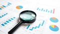 Analyzing Business Charts and Graphs with Magnifying Glass Royalty Free Stock Photo