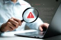 Troubleshooting computer error with magnifying glass for system failure and security vulnerability scan Royalty Free Stock Photo