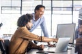 Analyzing data on computer screen, colleagues collaborating on project in office Royalty Free Stock Photo