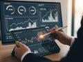 Analyzing financial data on tablet and computer screen with graphs and charts Royalty Free Stock Photo