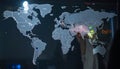 Analyzing Global Data on a Holographic World Map Royalty Free Stock Photo