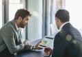 Analyzing profit and loss. two colleagues looking at a graph on a digital tablet together in an office. Royalty Free Stock Photo