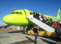 Passengers climb the ladder to the plane of the Siberian Airlines S7