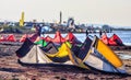 Colorful kites resting on sandy Black sea beach at sunset