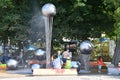 Anapa, Russia, July, 18, 2018. People walking near fountain with `hanging` over the streams of water balls in the city of Anapa Royalty Free Stock Photo