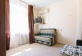 Anapa, Russia - June 25, 2020: The interior of a one-room apartment with an outdated poor interior