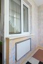 Anapa, Russia - March 3, 2020: Window opening to the balcony glazed with plastic windows, a battery is located under the window Royalty Free Stock Photo
