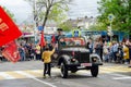 Anapa, Russia - May 9, 2019: Children give flowers to veterans driving a restored military car at the victory parade in Anapa