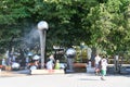 Anapa, Russia, July, 18, 2018. People walking near fountain with `hanging` over the streams of water balls in the city of Anapa Royalty Free Stock Photo