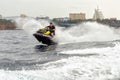 Jet ski watercraft man driver driving waterbike in Black Sea on city background making splashes Royalty Free Stock Photo