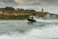 Jet ski watercraft man driver driving waterbike in Black Sea on steep cliff background making Royalty Free Stock Photo