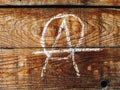 Anarchist symbol on wooden wall