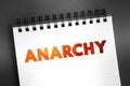 Anarchy - society being freely constituted without authorities or a governing body, text on notepad, concept background
