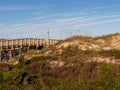 Anastasia State Park in St. Augustine, Florida at golden hour, with a wooden boardwalk and sand dune with a pretty blue sky. Royalty Free Stock Photo