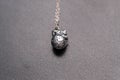 Anatomy 3D heart pendant with necklace silver color closeup. Selective Focus