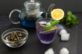 Anchan refreshing blue Thai tea in a glass cup with ice and lemon on a black background Royalty Free Stock Photo