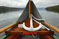 Anchor on boat nose on lake in cloudy weather