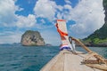 Anchor on the bow of a traditional Thai longtail boat near a small rocky island Royalty Free Stock Photo