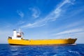 Anchor cargo yellow boat in blue sea Royalty Free Stock Photo