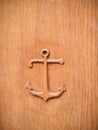 Anchor carved into a light wood door