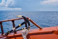 A anchor and deck of a wooden antique sailing yacht against the background of the sea and the blue sky Royalty Free Stock Photo