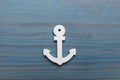 Anchor figure on light blue wooden table, top view