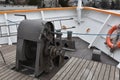 Anchor gear fixed in bow of a tourist cruiser ship painted white. Royalty Free Stock Photo